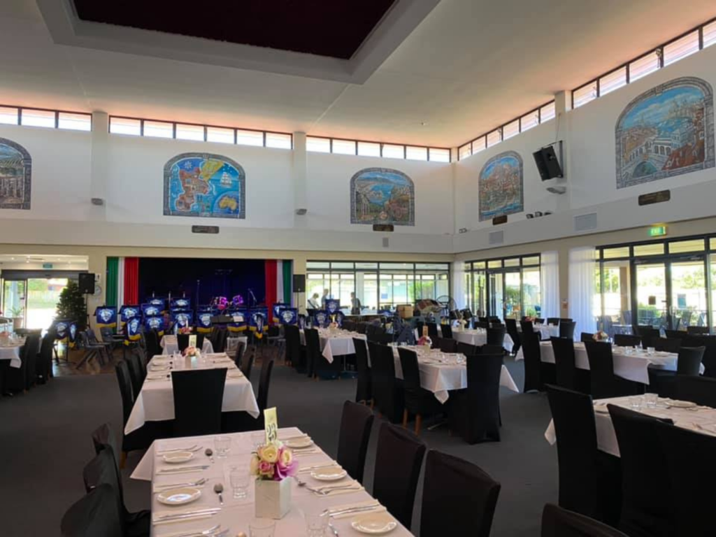 Large open bistro and bar space with stage area, dance floor and AV and lighting system. Tables set for fine dining service.